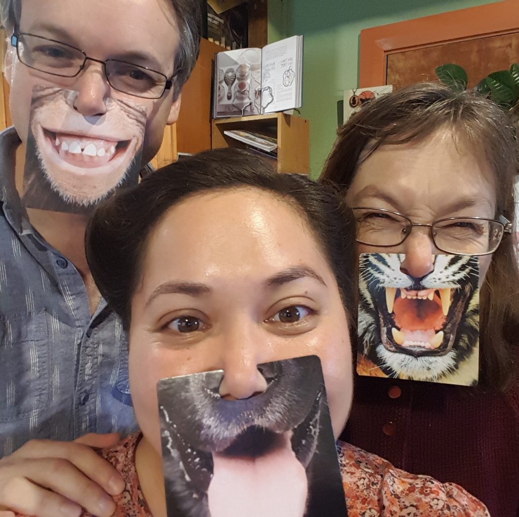 man, woman and child with funny animal masks
