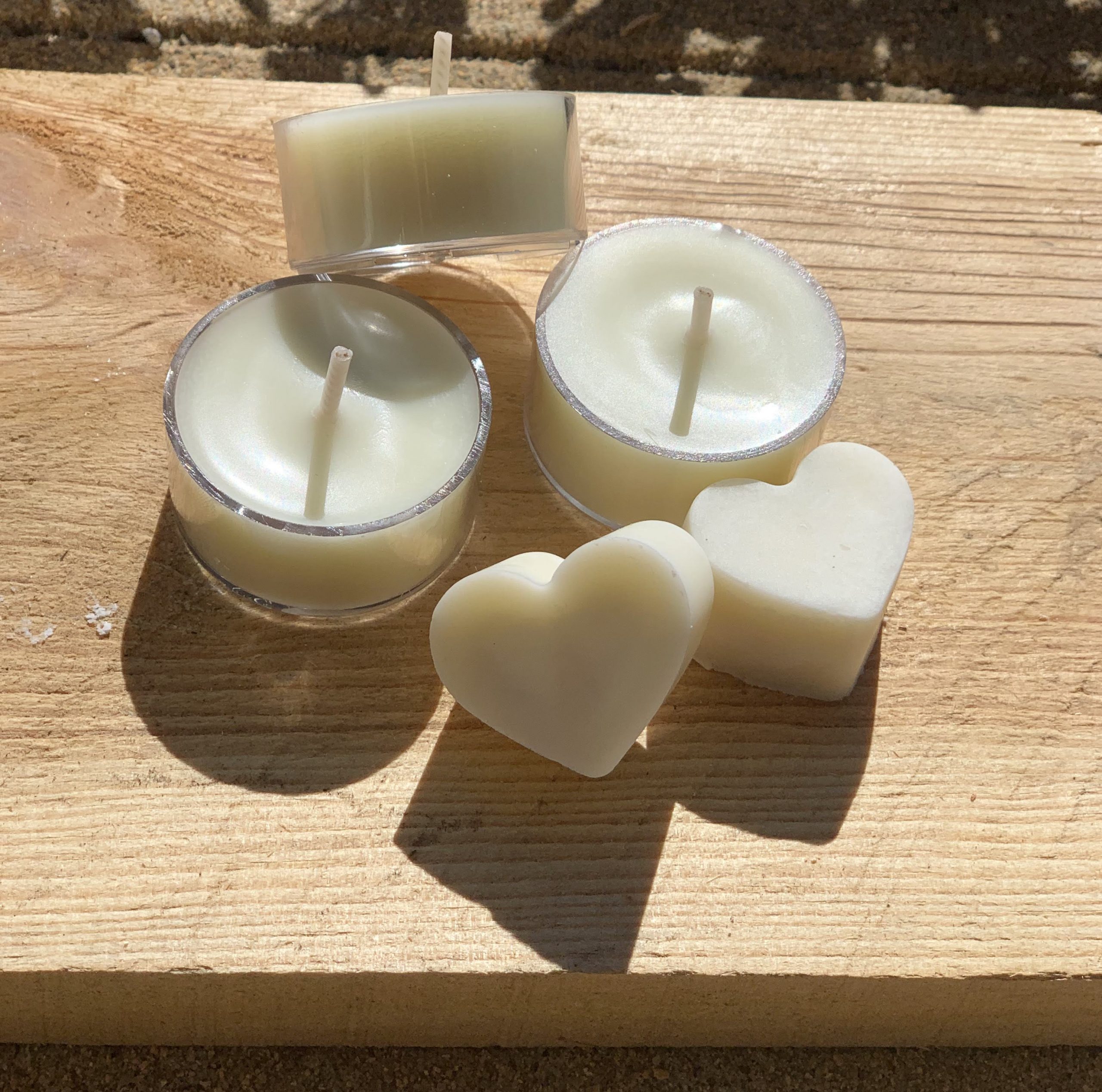 three small round candles and two heart-shaped melts.