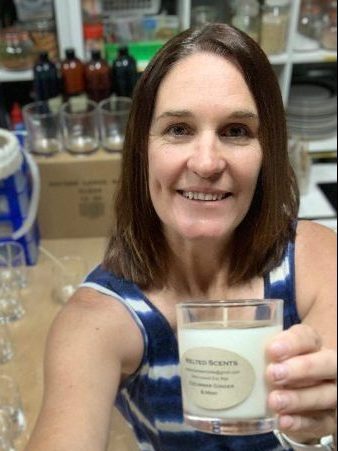 woman smiling holding candle